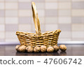 Walnuts in front of basket. 47606742