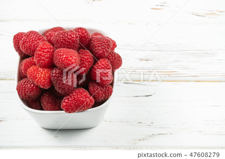 Plate with raspberry on rustic White background. Plate with raspberry on rustic White background. 47608279