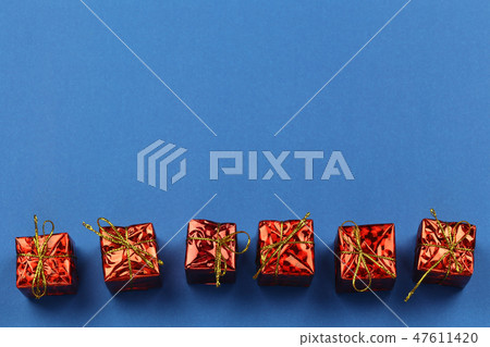 Red Gift Box of Christmas decorations on blue background and have copy space. Red Gift Box of Christmas decorations on blue background and have copy space. 47611420