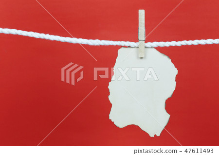 Empty old note paper hang on the clothesline and have copy space with red background. 47611493