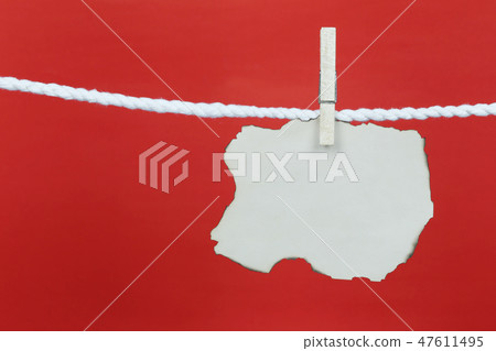 Empty old note paper hang on the clothesline and have copy space with red background. 47611495