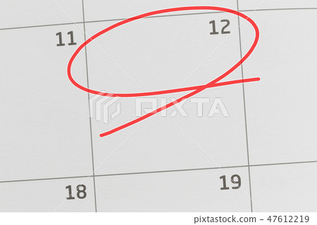 Focus on number 12 in calendar and empty red ellipse. 47612219