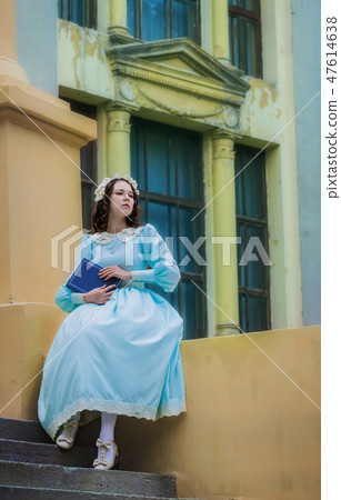 Young girl in a vintage dress reads a love story Young girl in a vintage dress reads a love story 47614638