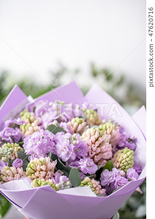Bouquets of pink hyacinths and matthiola of lilac color in vase on wooden table. Spring flowers from Bouquets of pink hyacinths and matthiola of lilac color in vase on wooden table. Spring flowers from 47620716