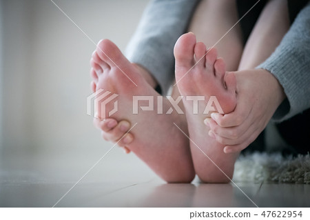 A young Japanese woman doing a foot massage 47622954