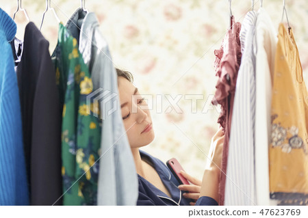 A woman getting dressed. 47623769