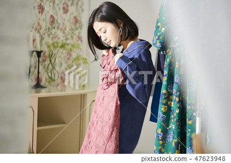 A woman getting dressed. A woman getting dressed. 47623948