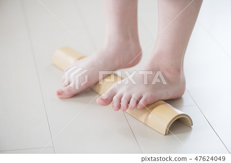 A young Japanese woman stamping Aoto bamboo 47624049