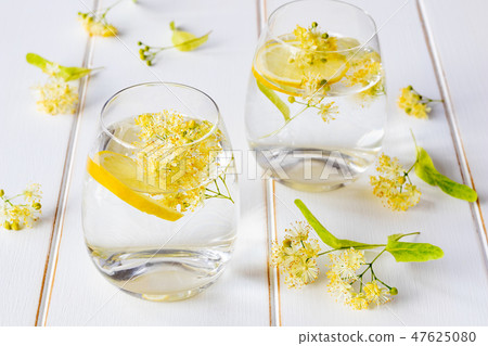 Linden lemonade and flowers on a white table 47625080