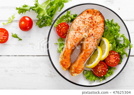 Salmon fish steak grilled and vegetable salad Salmon fish steak grilled and vegetable salad 47625304