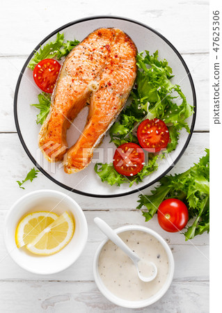 Salmon fish steak grilled and vegetable salad 47625306