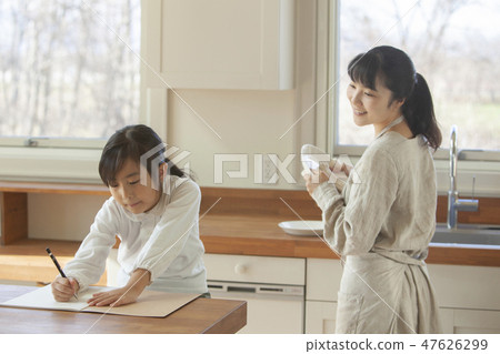 A girl studying in the kitchen 47626299