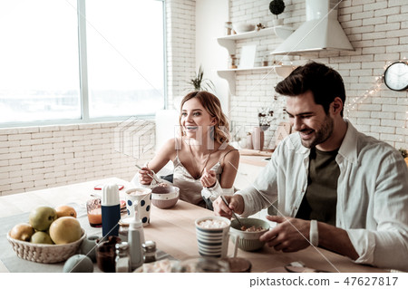 Young long-haired pretty woman in a white shirt and her husband feeling amazing Young long-haired pretty woman in a white shirt and her husband feeling amazing 47627817