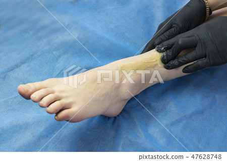 Process depilation female legs and hands in a beau Process depilation female legs and hands in a beau 47628748