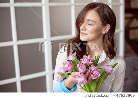 People, business, sale and floristry concept - close-up of florist woman holding bunch at flower People, business, sale and floristry concept - close-up of florist woman holding bunch at flower 47628909