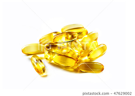 heap of fish oil supplement capsules 47629002