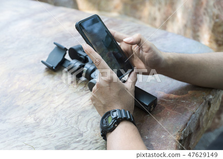 man hand use smart mobile with dji mobile on table 47629149