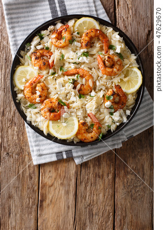 Mediterranean food Pasta orzo with grilled shrimps 47629670