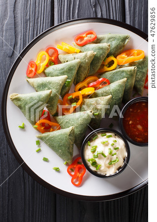 Vegetarian Spinach samosa with sauces close-up 47629856