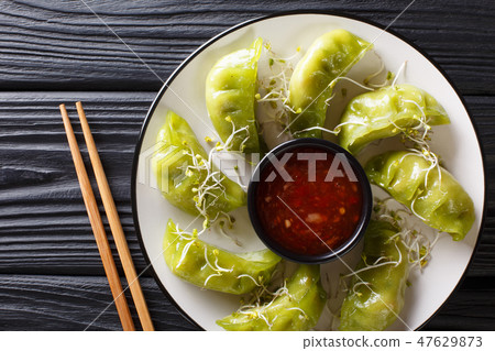 Fresh green gyoza dumplings with matcha 47629873