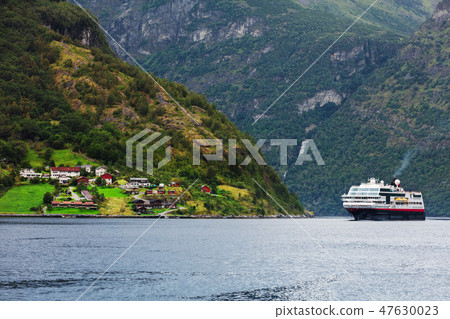 Cruise ship in Geiranger fjord. Cruise ship in Geiranger fjord. 47630023