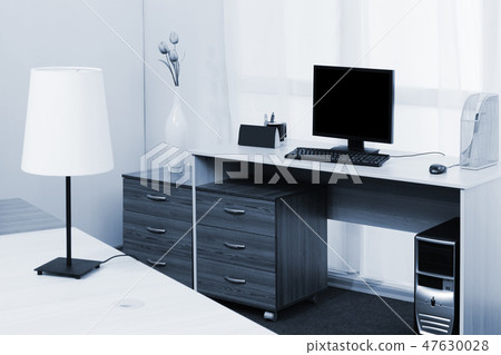 computer on a desk in a office 47630028