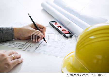 Construction engineering or architect hands working on blueprint 47630885
