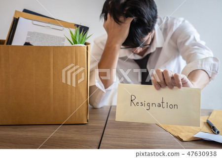 Stressed businessman will being resignation and packing belongin Stressed businessman will being resignation and packing belongin 47630938
