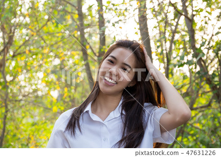 Portrait of asian college woman smiling in blur background witn sunset. Portrait of asian college woman smiling in blur background witn sunset. 47631226