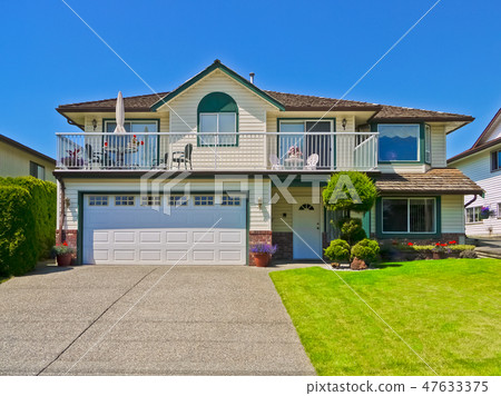 Average residential house with concrete driveway on blue sky background Average residential house with concrete driveway on blue sky background 47633375