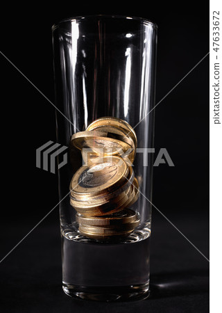 Glass for alcohol with Euro coins.  47633672