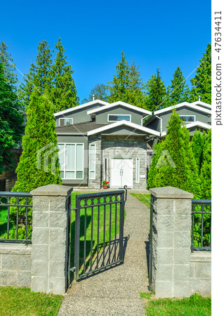 Main entrance of residential duplex house with open metal gate in front Main entrance of residential duplex house with open metal gate in front 47634411