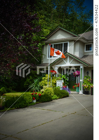 Main entrance of family house with canadian flag in front. Dark borders image 47634422