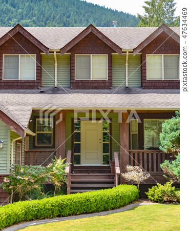 Entrance of big family house with green hedge on the front yard Entrance of big family house with green hedge on the front yard 47634469