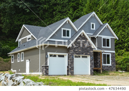 Brand new luxury residential house on green trees background 47634490