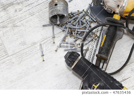 hammer drill and dowels on the wooden background 47635436