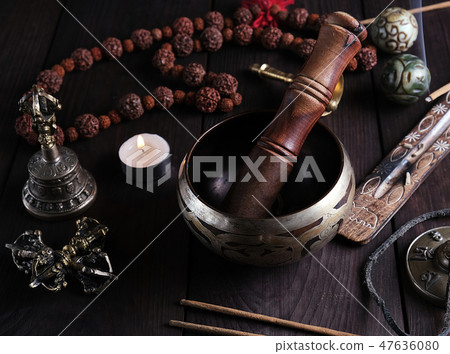 copper singing bowl and a wooden stick  47636080
