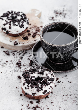 Black coffee cup with saucer and doughnuts  47636185