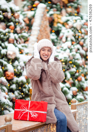 Happy girl near fir-tree branch in snow for new year. Happy girl near fir-tree branch in snow for new year. 47636269