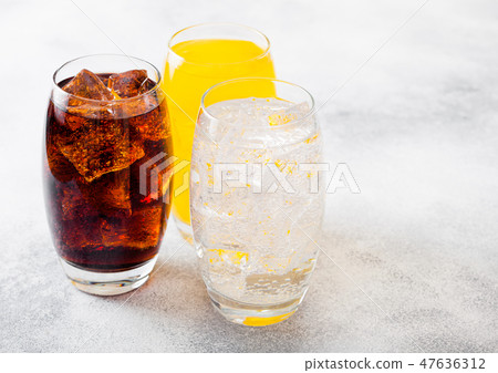 Glasses of soda drink with ice cubes and bubbles  47636312