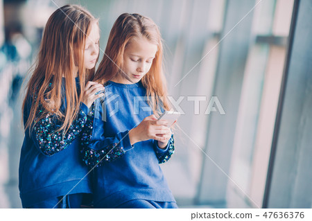 Little kids together in airport waiting for boarding 47636376