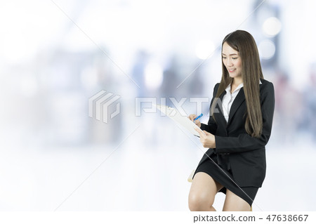 Businesswoman seated on chair and checking list. Businesswoman seated on chair and checking list. 47638667