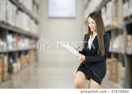 Businesswoman seated on chair and checking list. Businesswoman seated on chair and checking list. 47638668