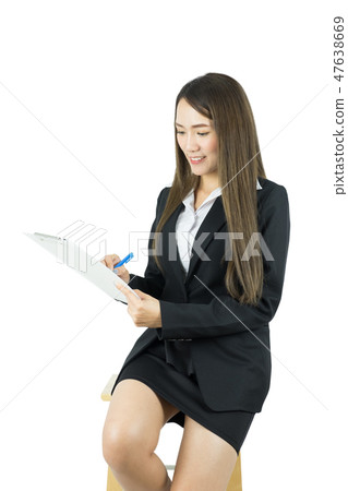 Businesswoman seated on chair and checking list. Businesswoman seated on chair and checking list. 47638669