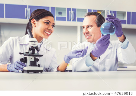 Long-haired female assistant smiling enjoying work Long-haired female assistant smiling enjoying work 47639013