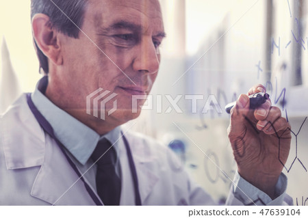 Serious experienced chemist creating new chemical formula 47639104