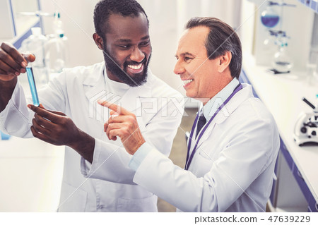 Two microbiologists feeling satisfied after their discovery Two microbiologists feeling satisfied after their discovery 47639229