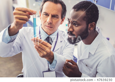 Skillful chemist teaching young promising assistant Skillful chemist teaching young promising assistant 47639230