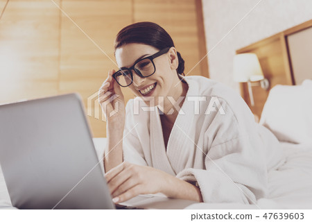 Young businesswoman in glasses using laptop Young businesswoman in glasses using laptop 47639603