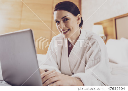 Positive freelancer working with the laptop Positive freelancer working with the laptop 47639604